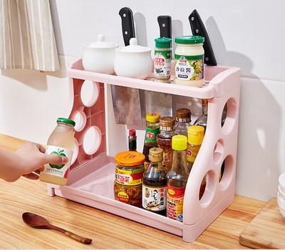 Pink kitchen storage rack with two open shelves and circular side cutouts