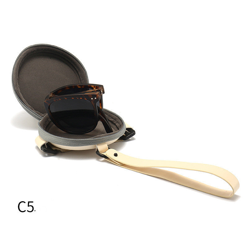 Foldable sunglasses with tortoiseshell frames and dark lenses, shown with hard case
