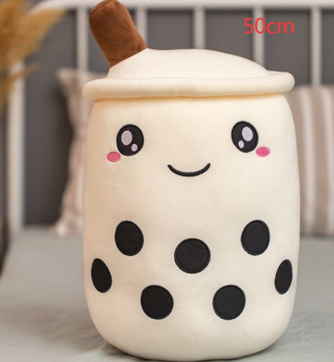 White plush boba tea cup pillow, brown straw, smiling face, and black circle pattern