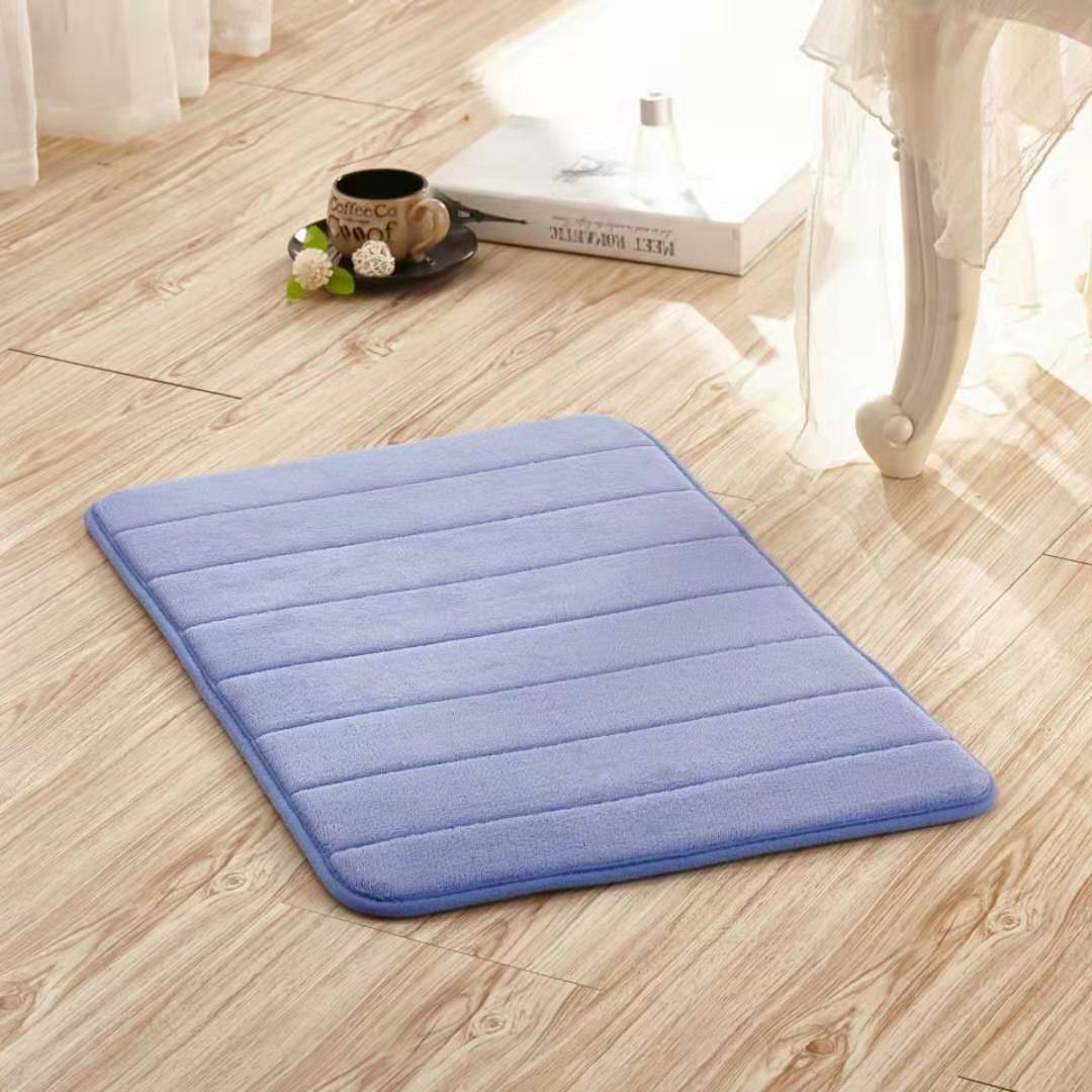 Light blue non-slip washable toilet floor mat with quilted stripes and rounded edges