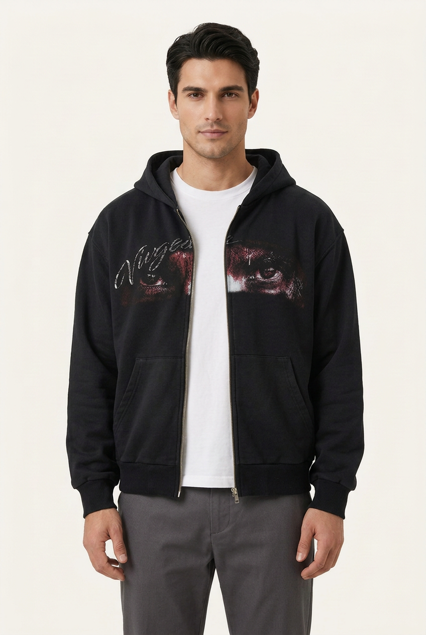 Male model wearing the black eye graphic hoodie fully unzipped over a white T-shirt