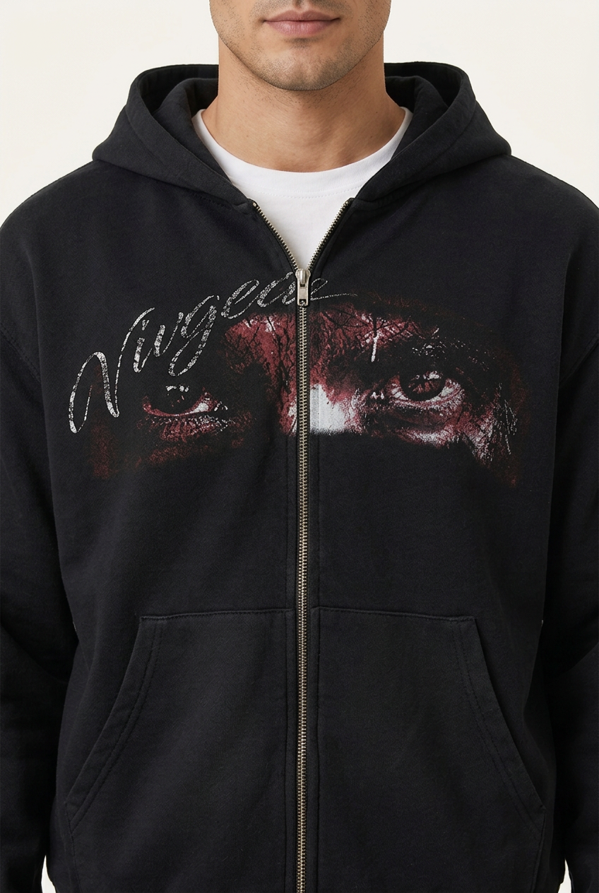 Black hoodie eye graphic and zipper detail on model